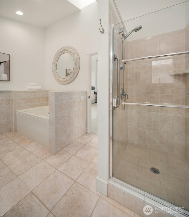 4582 Point White Dr NE, Bainbridge Island, WA 98110 - bathroom with tile patterned floors, a shower stall, a bath, recessed lighting, and tile walls