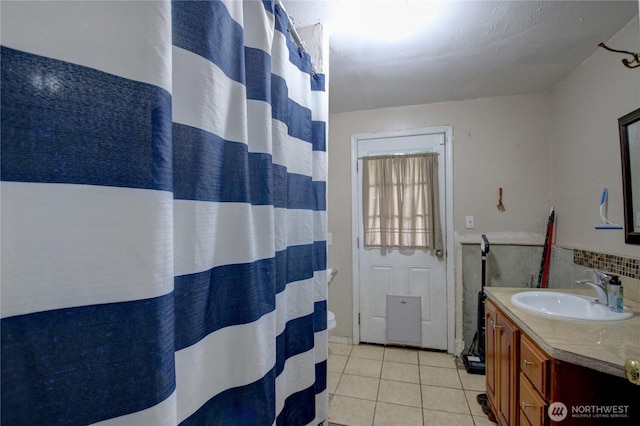 bathroom with a shower with shower curtain, tile patterned flooring, and vanity