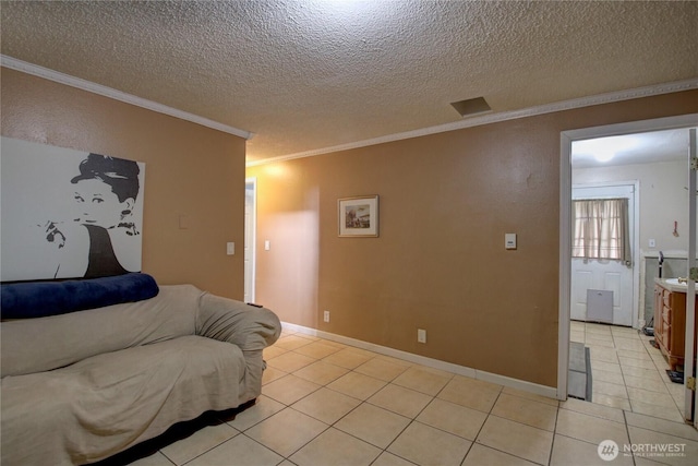 living room with a textured ceiling, ornamental molding, and light tile patterned flooring