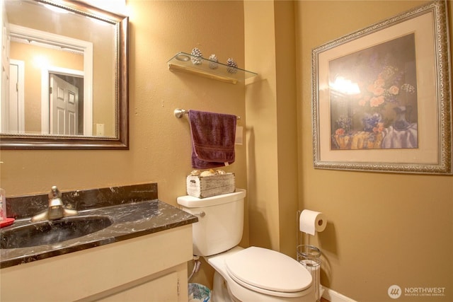 bathroom with toilet and vanity