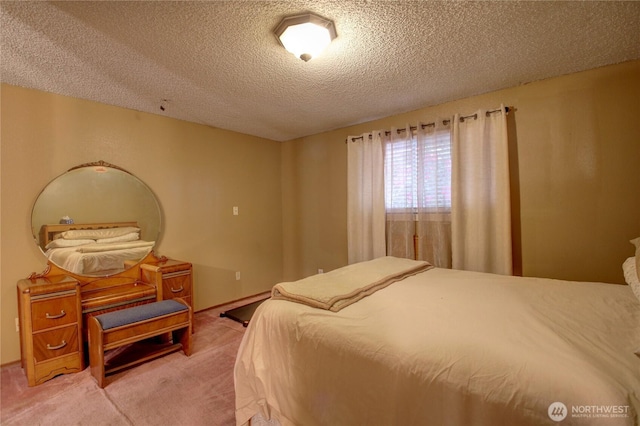 bedroom featuring a textured ceiling and light colored carpet