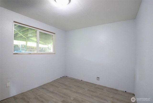 unfurnished room with light wood finished floors