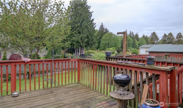 wooden terrace with a lawn and a fenced backyard