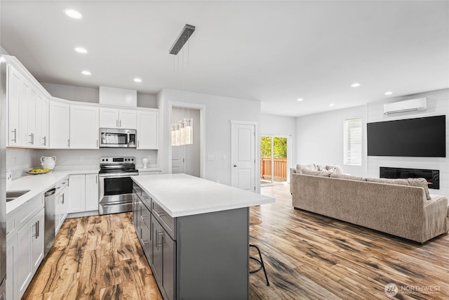 1824 E Fairbanks St, Tacoma, WA 98404 - kitchen with appliances with stainless steel finishes, a wall mounted AC, gray cabinets, white cabinets, and recessed lighting