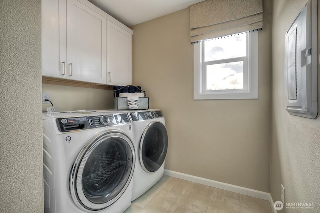laundry area with washer and dryer, cabinet space, and baseboards