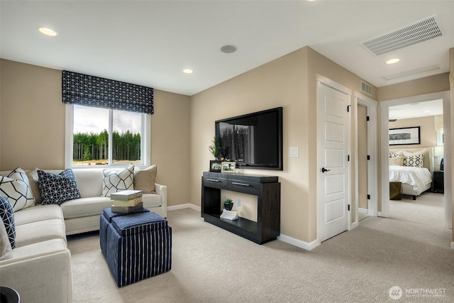 living area featuring baseboards, visible vents, light colored carpet, and recessed lighting