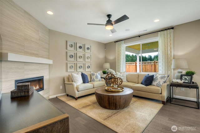 living room featuring recessed lighting, a fireplace, ceiling fan, visible vents, and wood finished floors