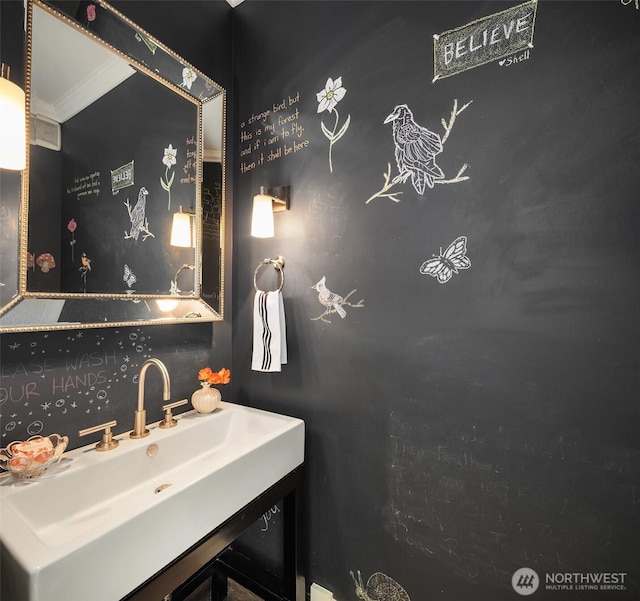 bathroom with a sink and ornamental molding