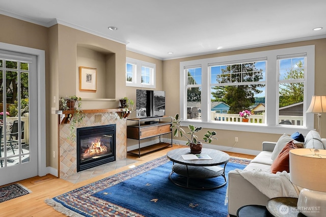 7854 Stroud Ave N, Seattle, WA 98103 - living area featuring wood finished floors, a fireplace, baseboards, ornamental molding, and recessed lighting
