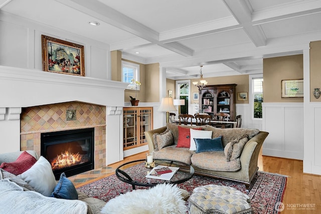7854 Stroud Ave N, Seattle, WA 98103 - living room with a wainscoted wall, beam ceiling, a fireplace, light wood finished floors, and coffered ceiling