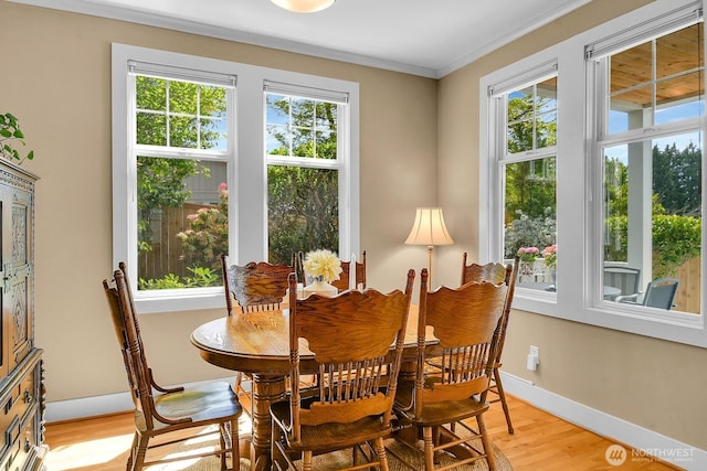 7854 Stroud Ave N, Seattle, WA 98103 - dining room with crown molding, baseboards, and light wood-type flooring
