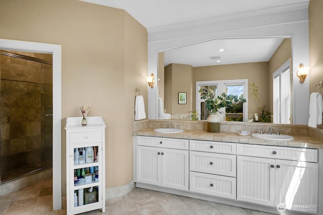 7854 Stroud Ave N, Seattle, WA 98103 - bathroom with double vanity, tile patterned floors, a sink, and a stall shower