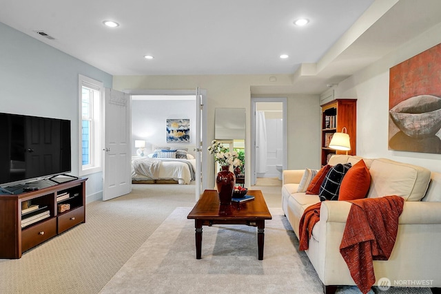 7854 Stroud Ave N, Seattle, WA 98103 - living area with light carpet, baseboards, visible vents, and recessed lighting