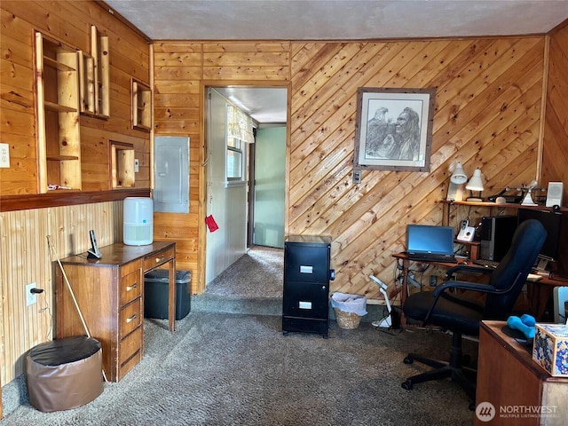 carpeted office space featuring electric panel and wood walls