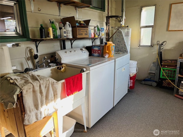 laundry area featuring washer and dryer, water heater, and carpet flooring