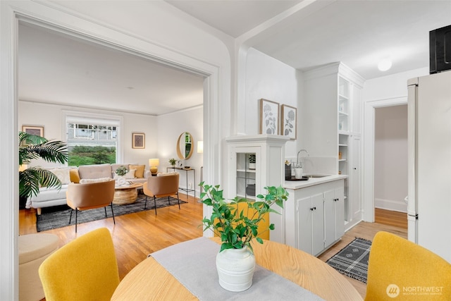 dining area featuring light wood-style flooring