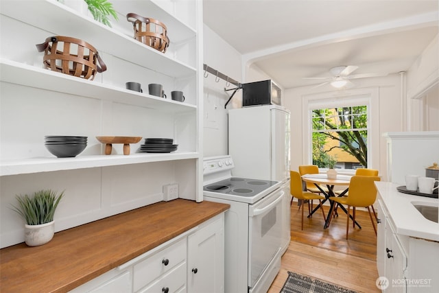 kitchen featuring open shelves, light wood-style floors, white electric range, white cabinetry, and a ceiling fan