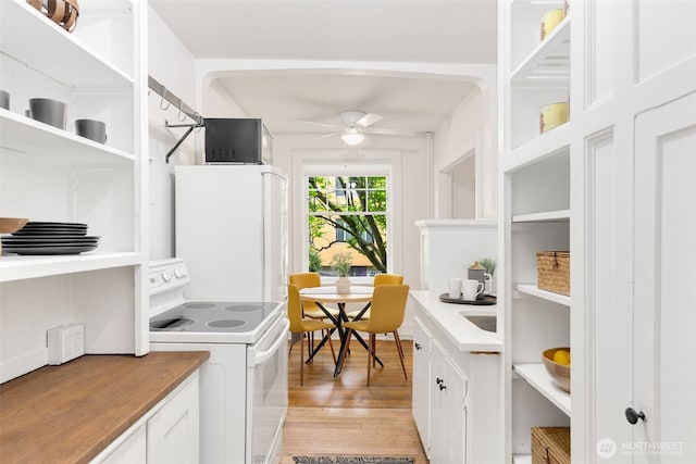 laundry area with light wood-style floors and a ceiling fan