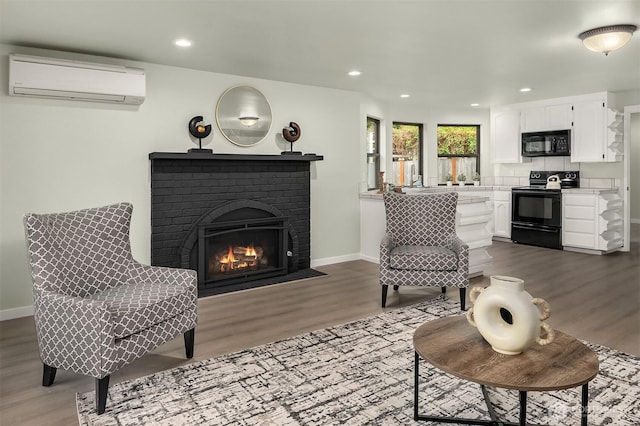 living room with an AC wall unit, baseboards, and dark wood-style floors