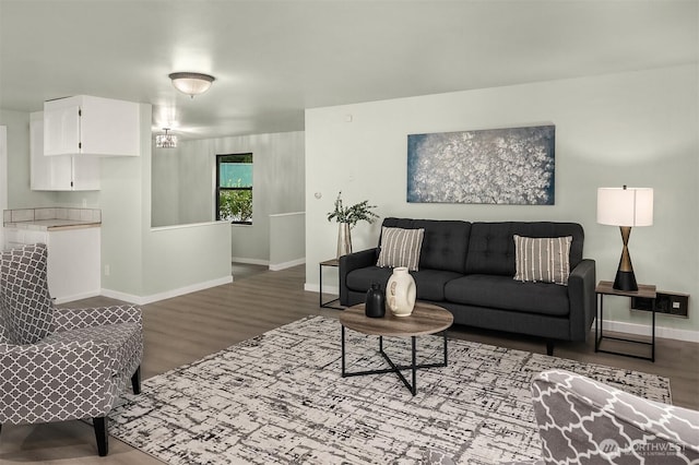 living area with baseboards and wood finished floors