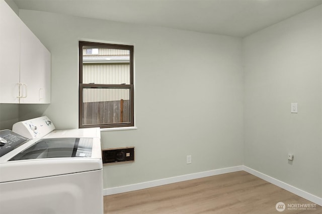laundry room with baseboards, washer and clothes dryer, cabinet space, and light wood-style flooring
