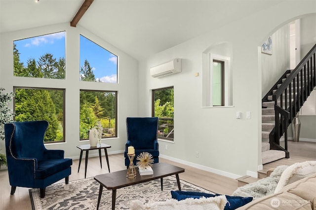 living room with arched walkways, a wall mounted AC, light wood-type flooring, high vaulted ceiling, and beamed ceiling