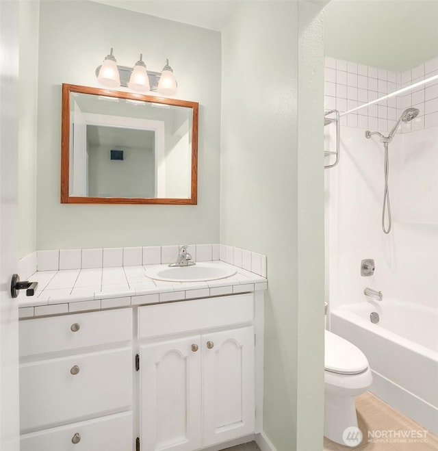 bathroom featuring vanity, toilet, and shower / tub combination