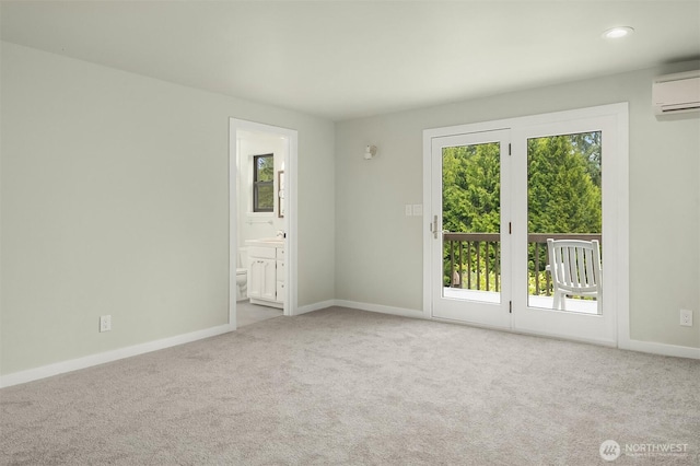 carpeted spare room with recessed lighting, baseboards, plenty of natural light, and a wall mounted air conditioner