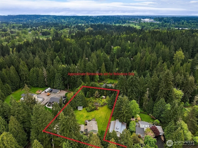 birds eye view of property featuring a view of trees
