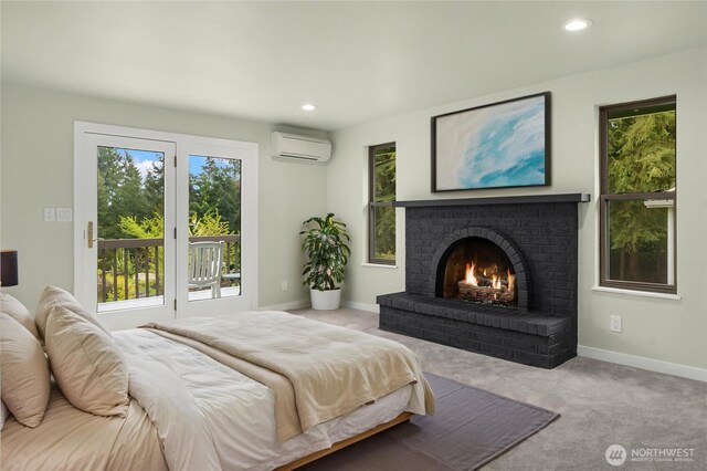 bedroom with access to exterior, baseboards, recessed lighting, a wall unit AC, and carpet