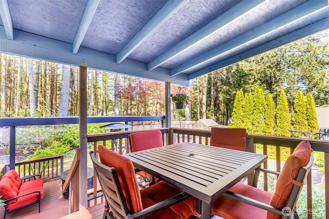 wooden terrace with outdoor dining space