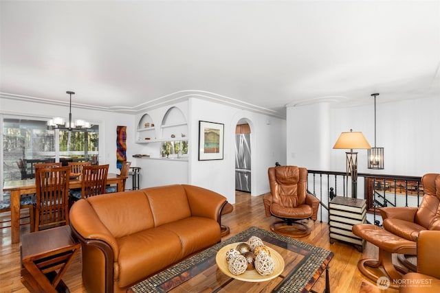 living area with wood finished floors and a chandelier