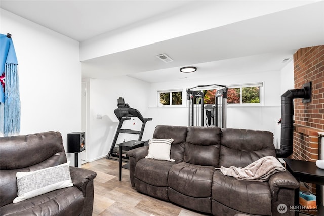 living area with light wood-type flooring and visible vents