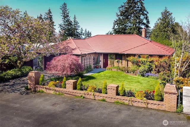 12715 Palatine Ave N, Seattle, WA 98133 - view of front of house featuring a tile roof, a front lawn, and a chimney