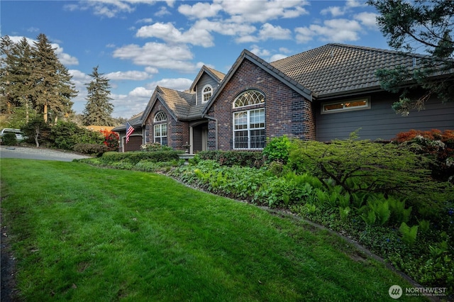 10910 48th Street Ct E, Edgewood, WA 98372 - view of front facade with a front yard, brick siding, and a tiled roof