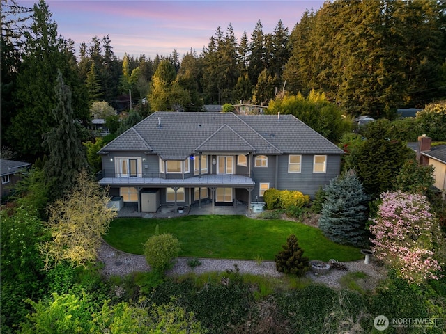 10910 48th Street Ct E, Edgewood, WA 98372 - back of property with a tile roof, a lawn, and a patio
