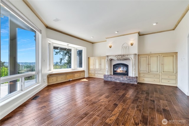 10910 48th Street Ct E, Edgewood, WA 98372 - unfurnished living room featuring crown molding, dark wood-type flooring, and a premium fireplace