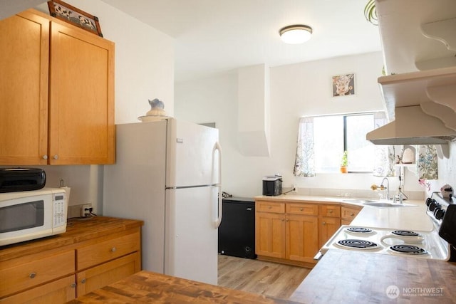 616 Pleasant St, Walla Walla, WA 99362 - kitchen with light countertops, light wood-type flooring, white appliances, and a sink