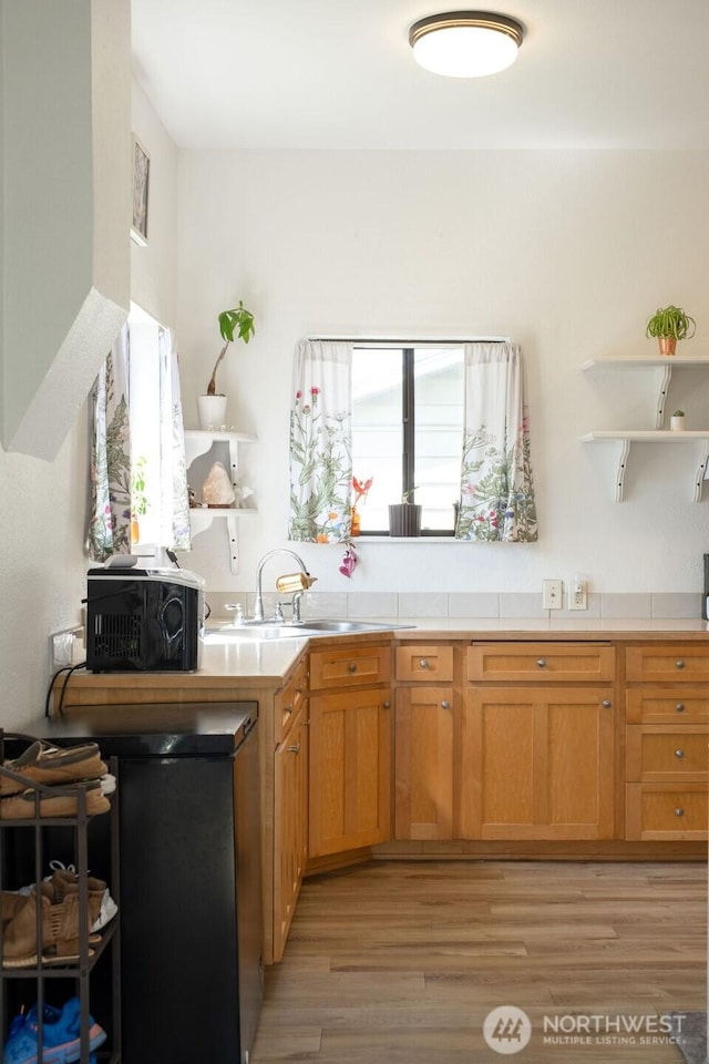 616 Pleasant St, Walla Walla, WA 99362 - kitchen with brown cabinetry, open shelves, tile countertops, a sink, and light wood-style flooring