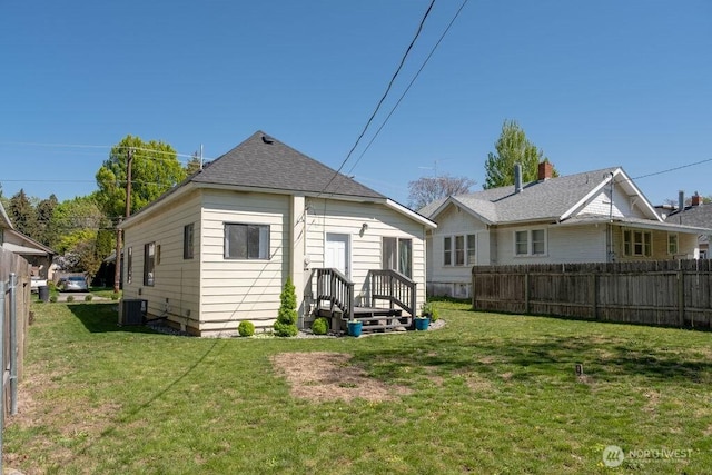 616 Pleasant St, Walla Walla, WA 99362 - back of property with fence, central air condition unit, a lawn, and roof with shingles