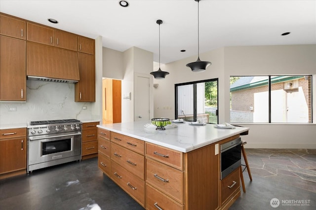 kitchen with brown cabinets, wall oven, hanging light fixtures, and high end stainless steel range oven