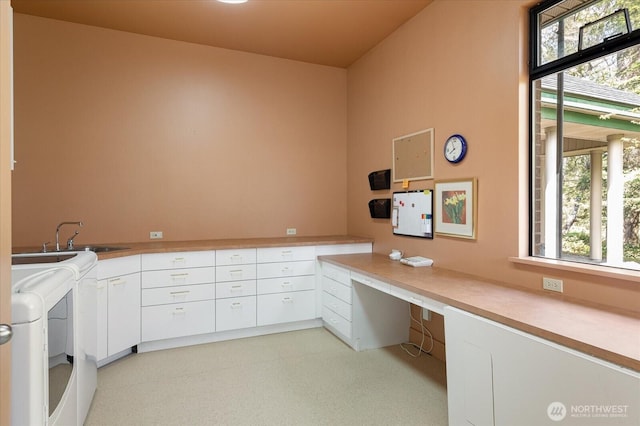 clothes washing area with a sink, cabinet space, independent washer and dryer, and a wealth of natural light