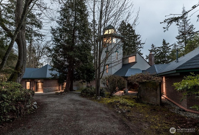 exterior space with brick siding and driveway