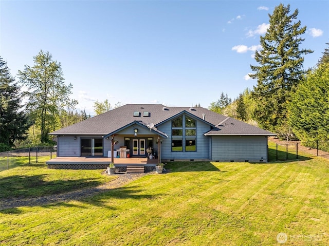 rear view of house with a fenced backyard, a lawn, a deck, and crawl space