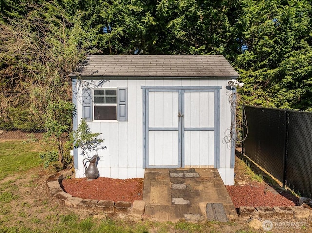 view of shed with fence