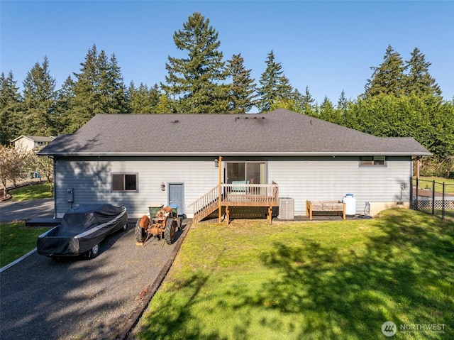 back of house with a lawn, a deck, and central AC unit