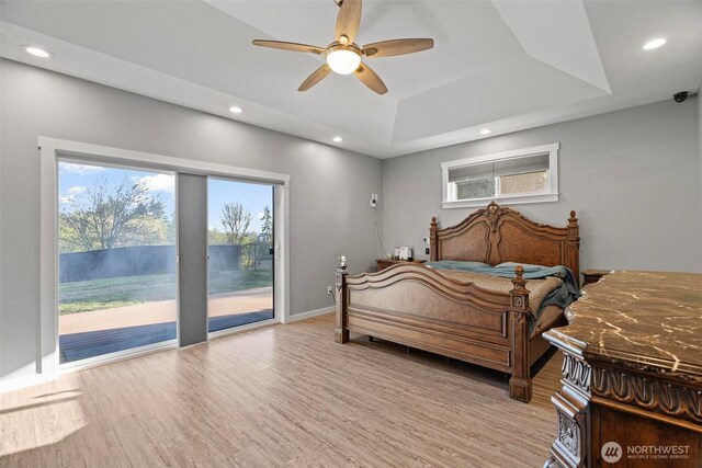 bedroom featuring multiple windows, recessed lighting, light wood-style flooring, and access to exterior