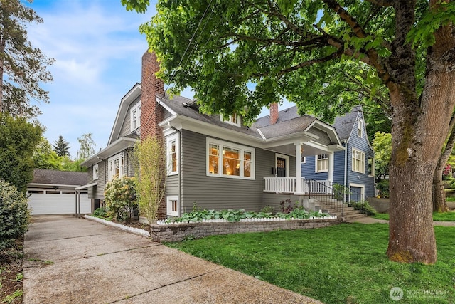 view of front of house featuring a porch, a chimney, a front yard, an outbuilding, and a shingled roof