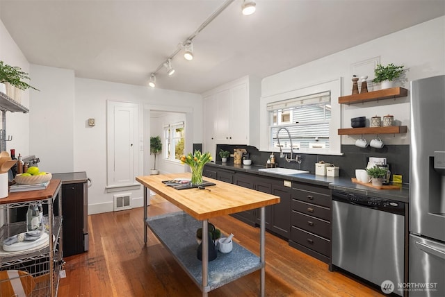kitchen with a sink, appliances with stainless steel finishes, plenty of natural light, and visible vents