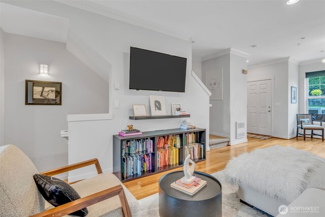 living room featuring visible vents, ornamental molding, wood finished floors, baseboards, and recessed lighting
